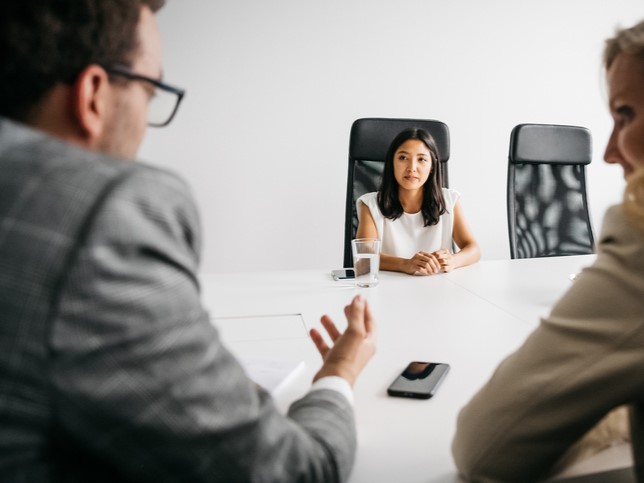 woman candidate at job interview answering where do you see yourself in 5 years interview question