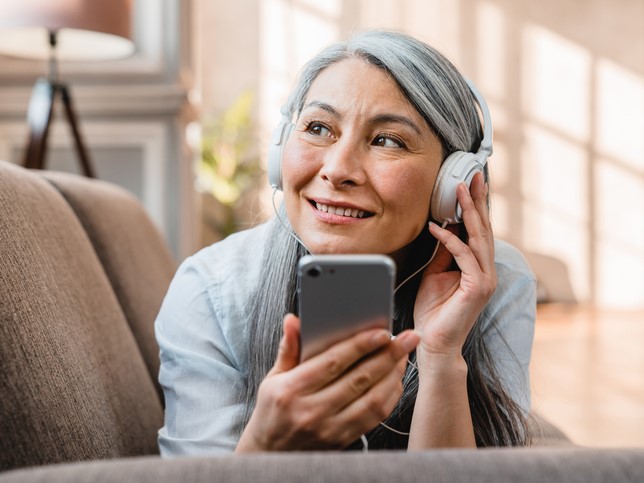 woman listening to best podcasts for therapists on phone