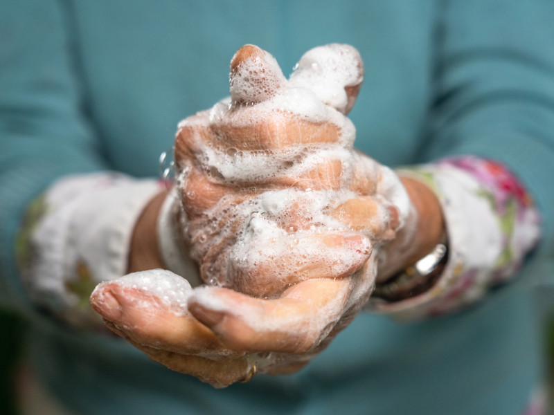Close-up of healthcare provider washing soapy hands