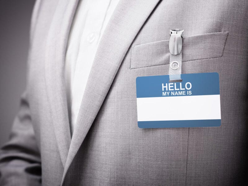 blank name tag on man's gray suit