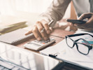 real estate broker using a calculator working