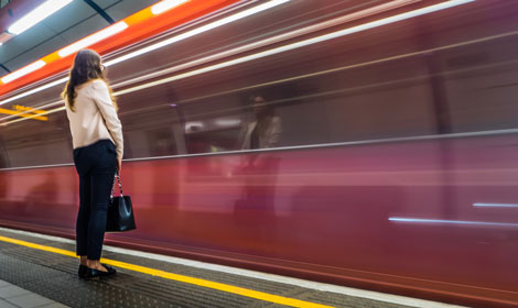 woman waiting by a moving subway train 470x280