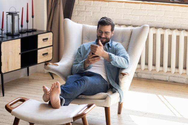 man shopping from home on mobile phone