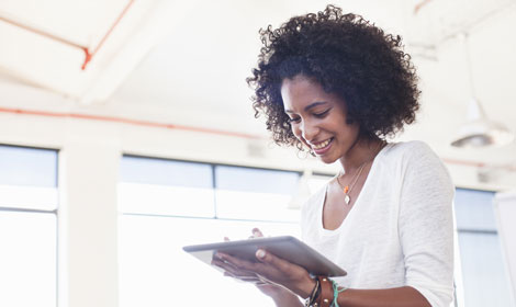 woman smiling using tablet work 470x280