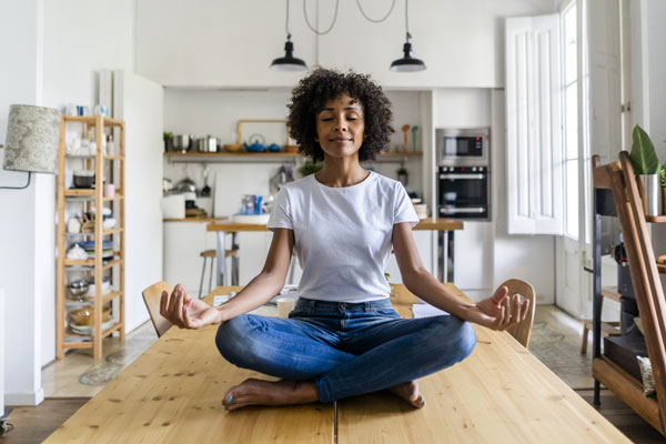 Woman on table meditating (Blog: 600x400)