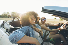 women driving in a convertible car (Auto Industry Report)
