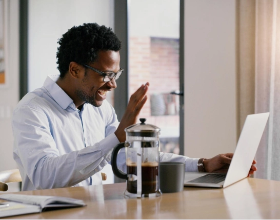 man waving at computer