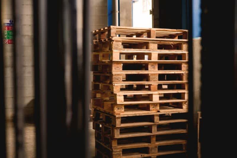 A stack of wooden pallets in a warehouse.
