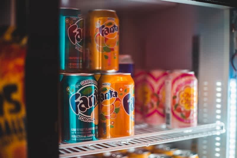 a refrigerator full of fanta soda of different flavors