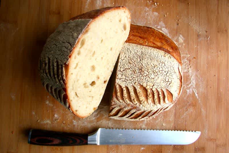 Sourdough bread cut in half on a cutting board