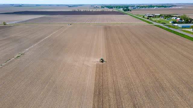 an overhead shot of a tractor plowing fields