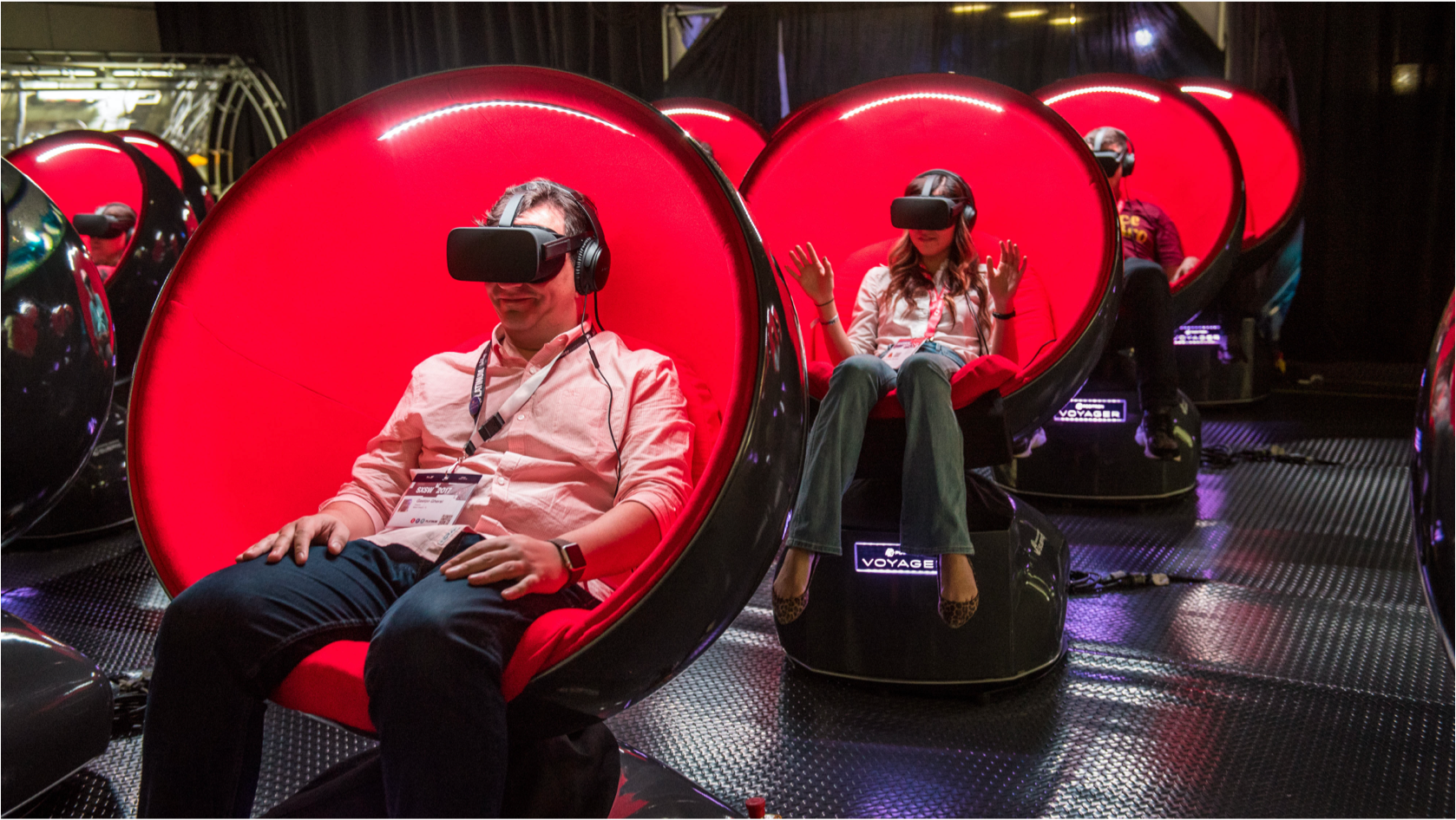 People sitting in red chairs in a virtual re