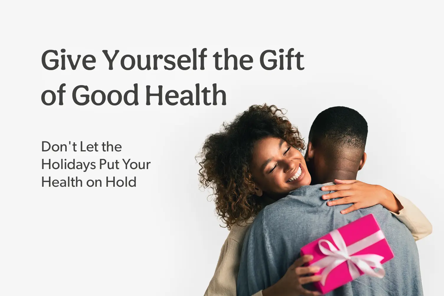 Happy couple hugging while exchanging a gift after finding affordable medical care through MDsave