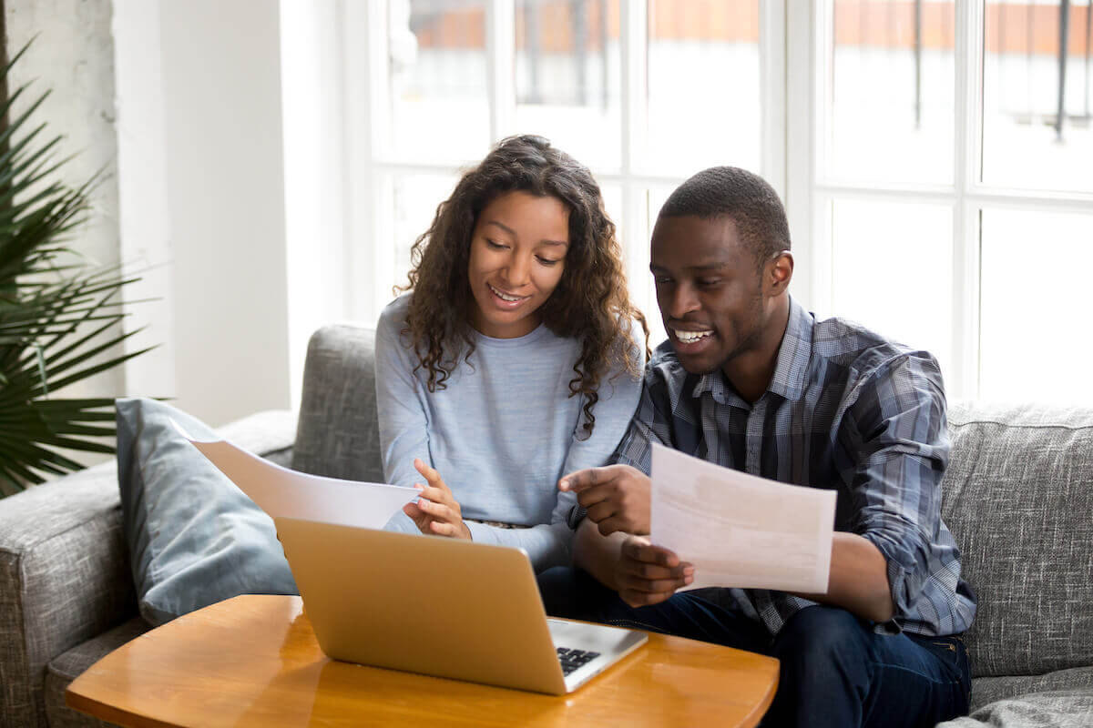 Types of savings accounts: happy couple going through documents