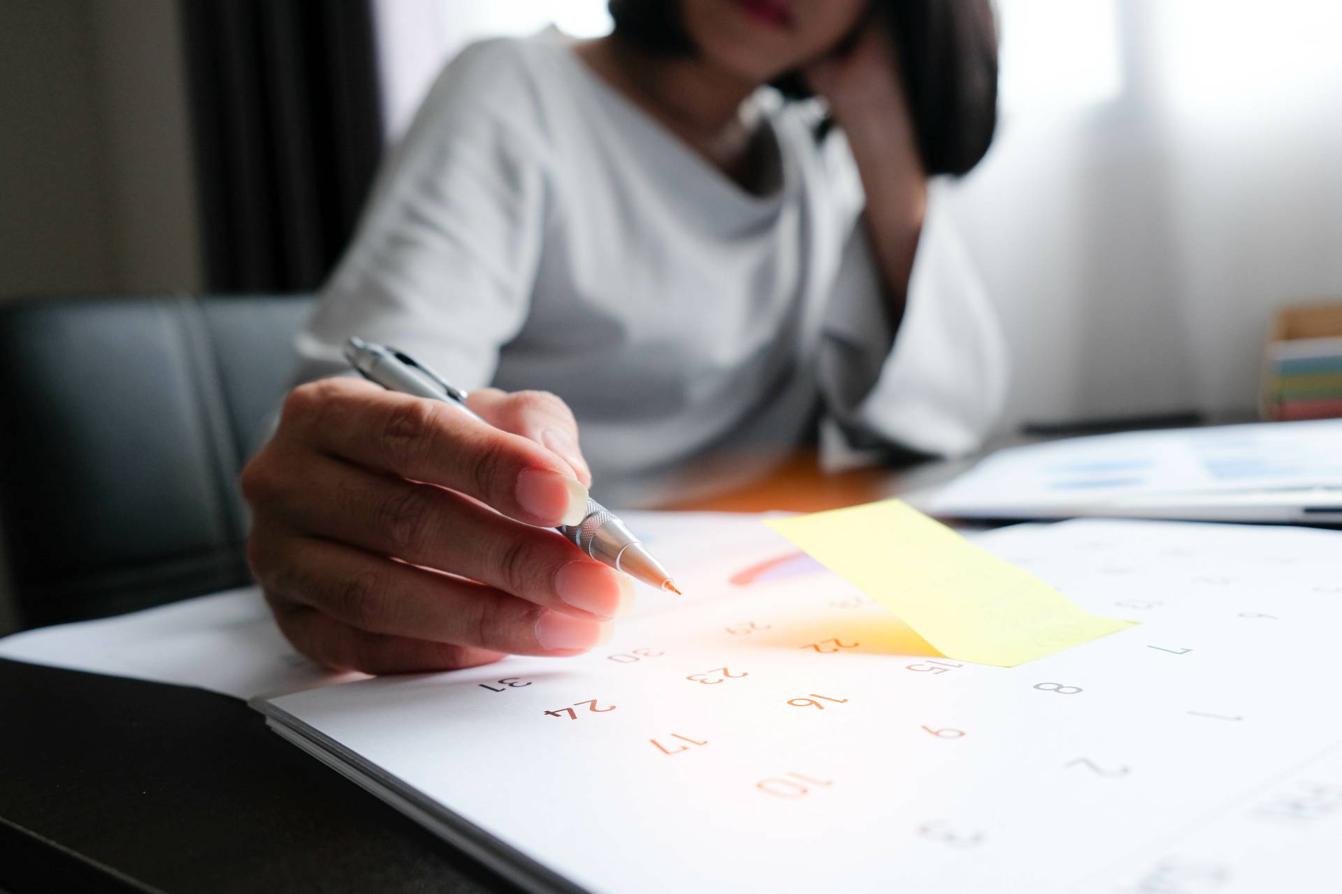 Woman with calendar figuring out finances
