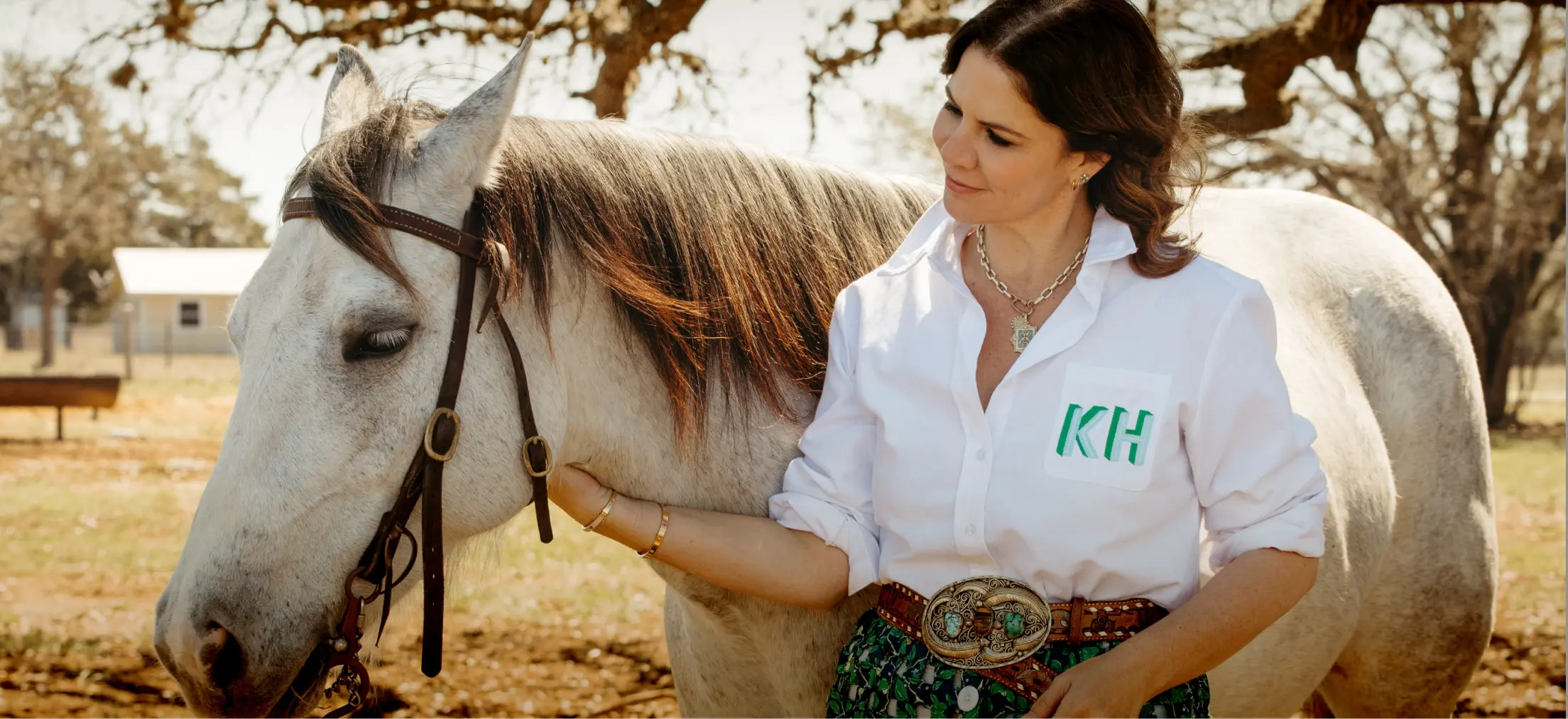 a woman wearing a charlotte oxford with her initals embroidered on it