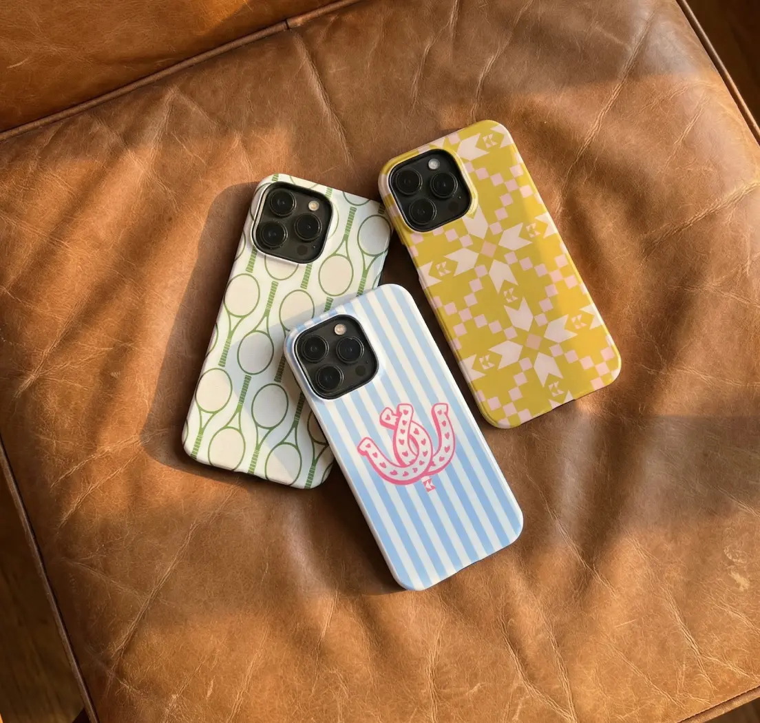cell phone cases sitting on a leather sear