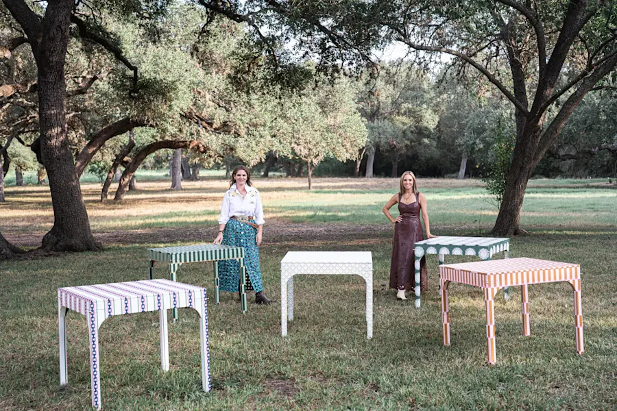 Avella Interiors game tables in Katie Kime prints, set out on the lawn under the oaks