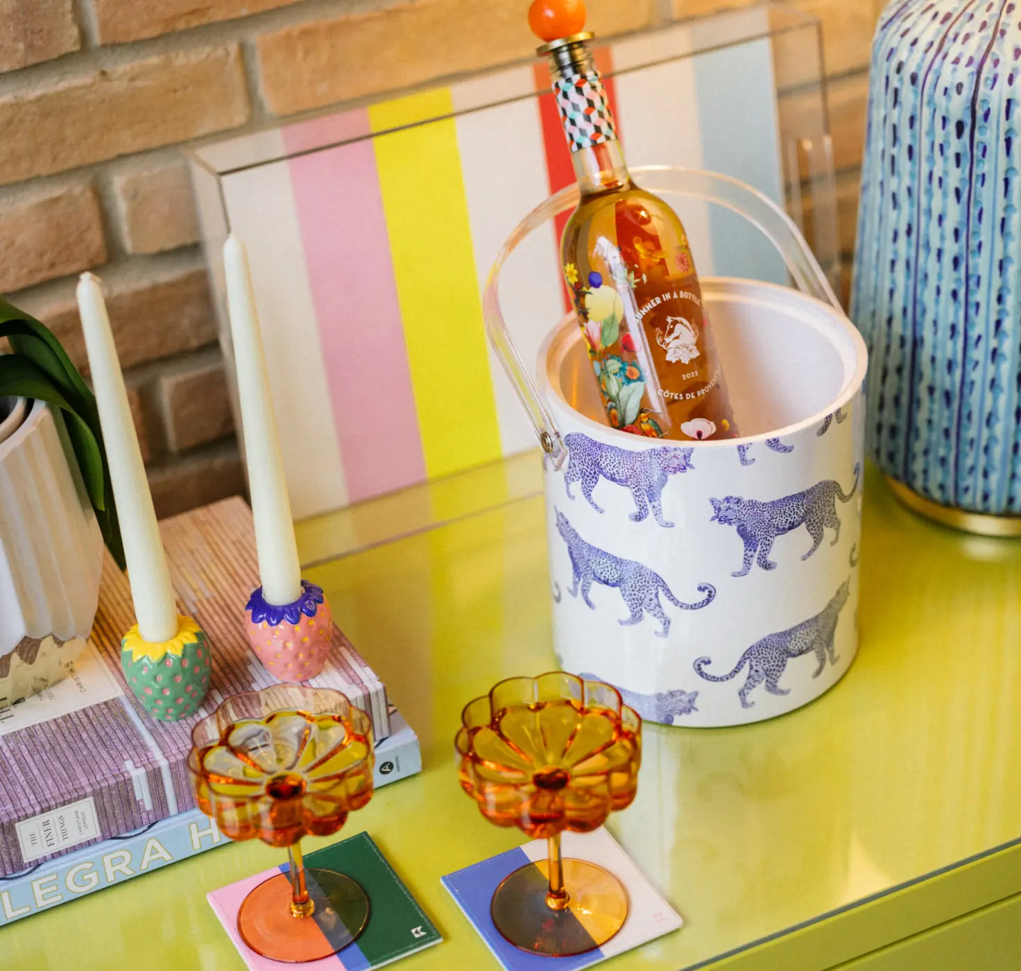 an ice bucket, coaster set, and lucite tray with katie kime prints