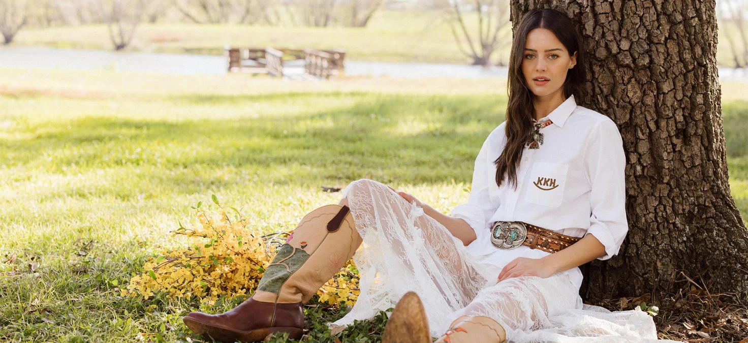 Woman wearing a charlotte oxfordwith embroidery. Katie Kime is an American lifestyle brand where classic prep meets wide-open Texas.