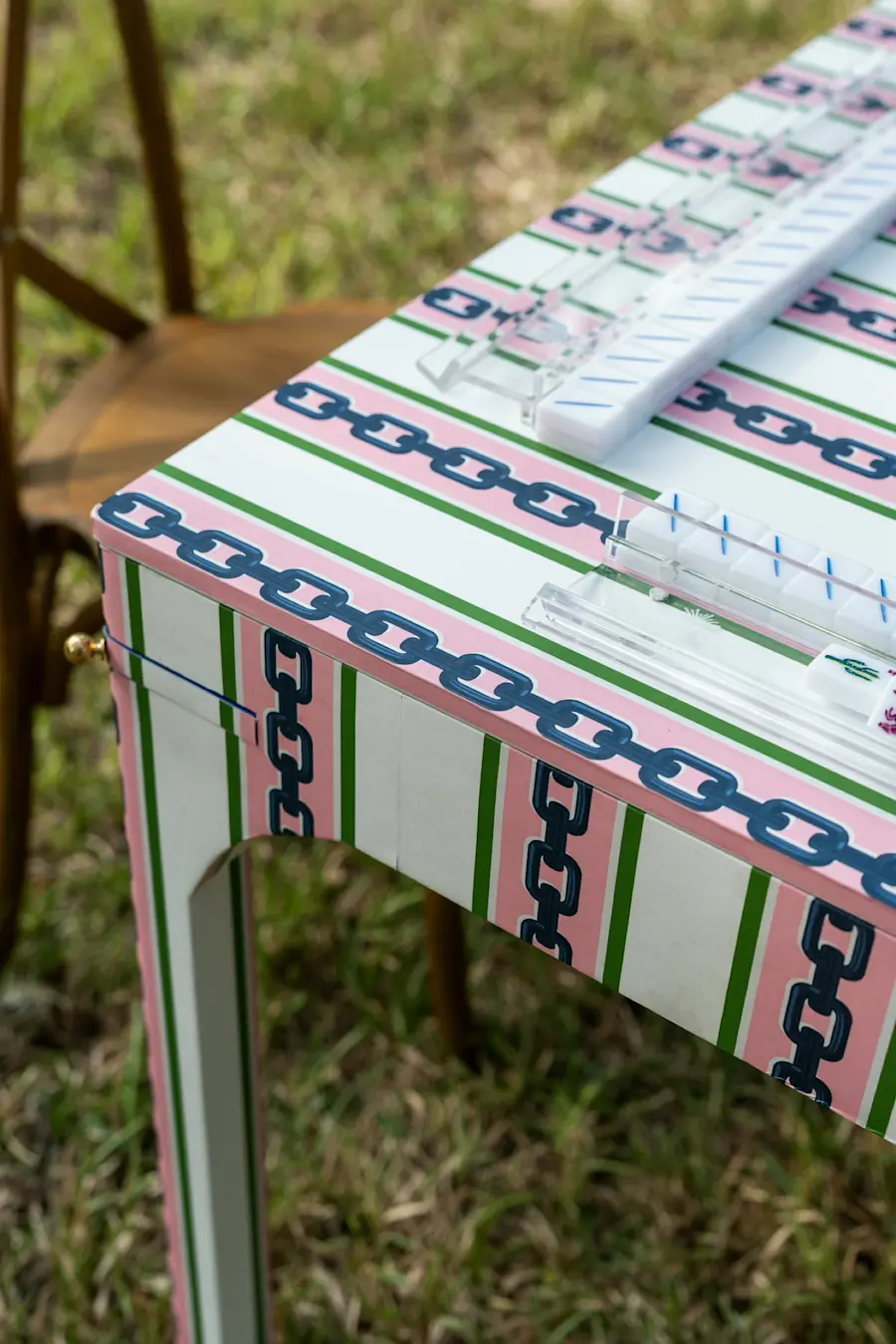 Close-up of a game table wrapped in Katie Kime Chain Stripe Pink