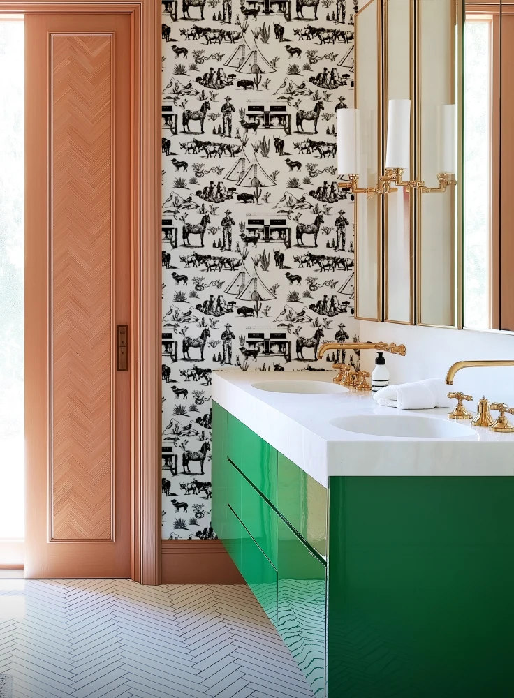 a bathroom with a green vanity and the marfa wallpaper