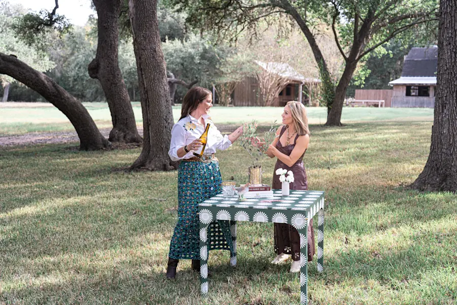 Katie Kime and Elizabeth Autenreith at a game table outdoors