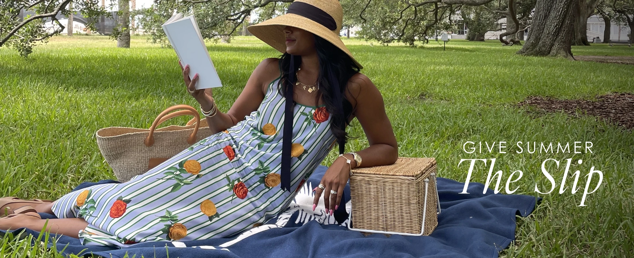 A woman in a park wearing the katie kime slip dress in the derby rose print