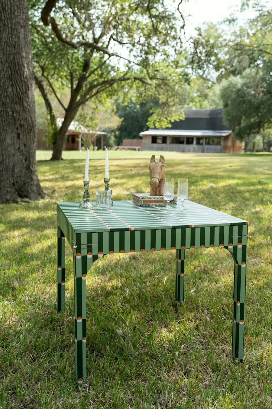 The Palisades Green game table set with candlesticks and a mahjong set