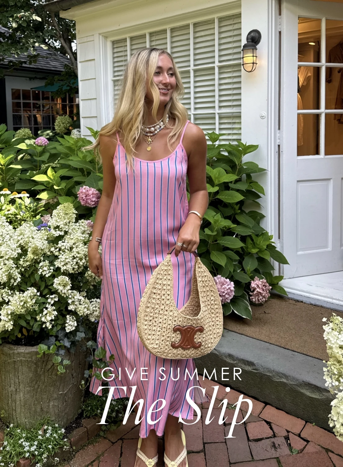 A woman outside wearing the katie kime slip dress in the tailored stripe print