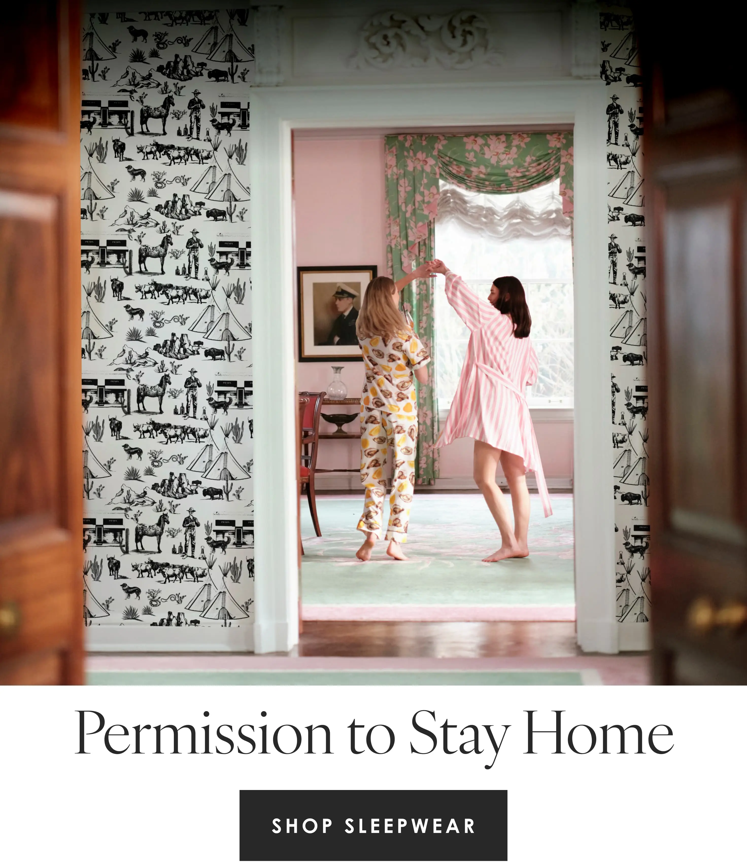 two women dancing in a room wearing katie kime pajamas. One woman is wearing the world is your oyster print pants set and the other is wearing the retro stripe pink robe