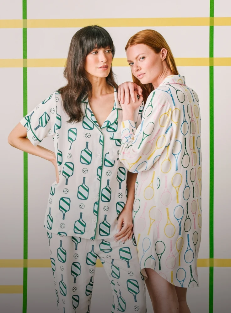 Two women wearing Pickleball pajamas and tennis time pajamas