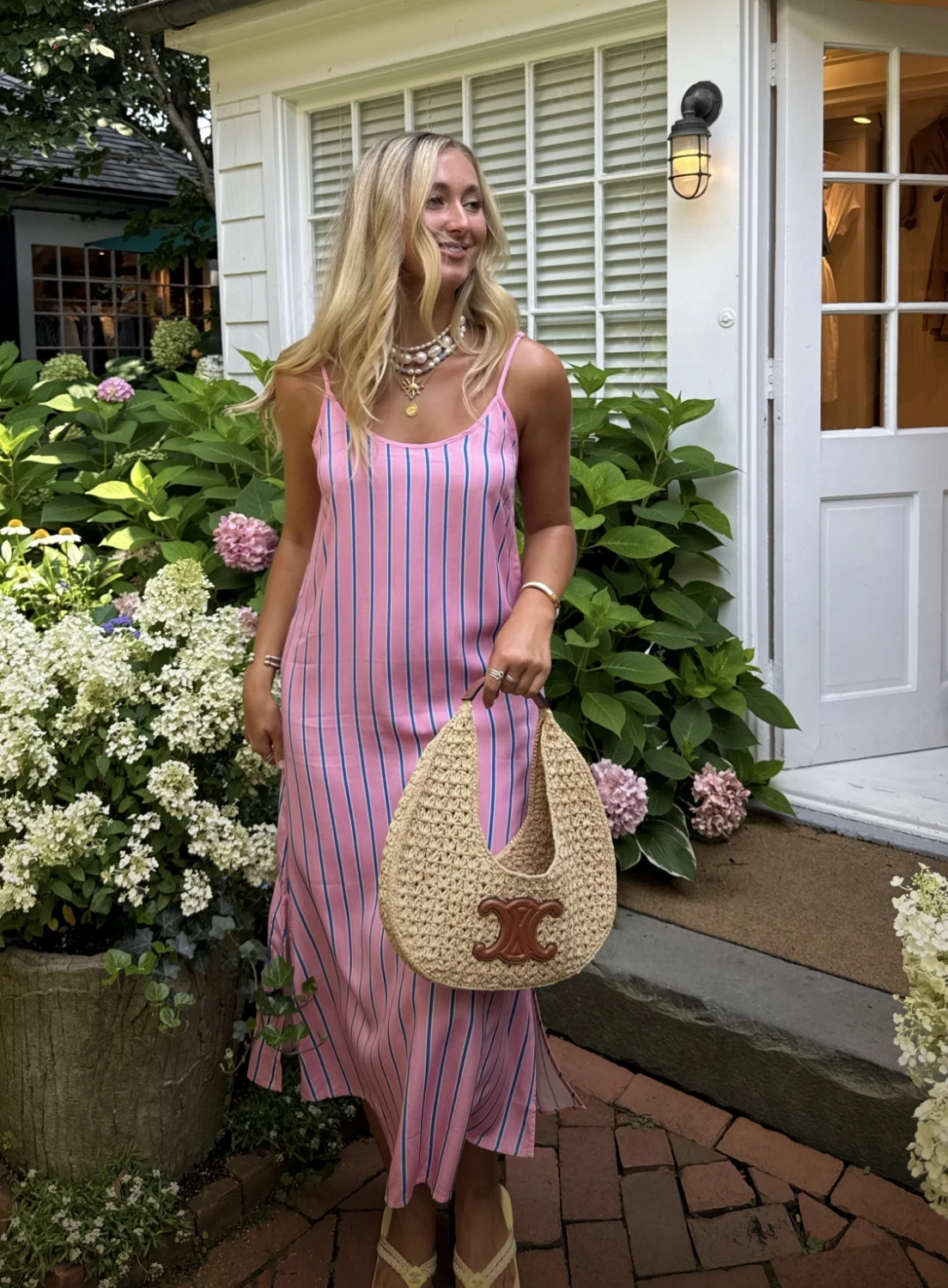 An influencer wearing tailored stripe slip dress