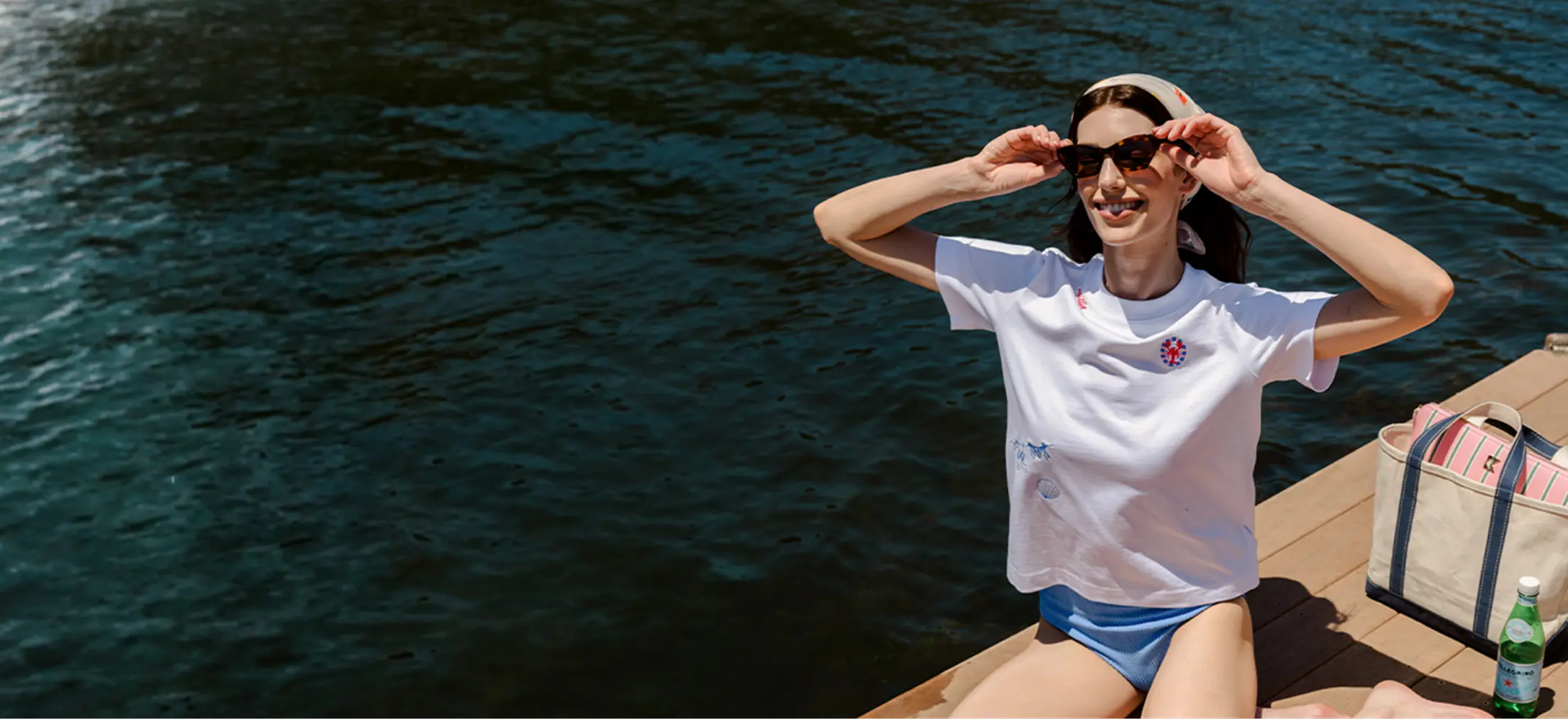 a woman by the water wearing the katie kime summer tee