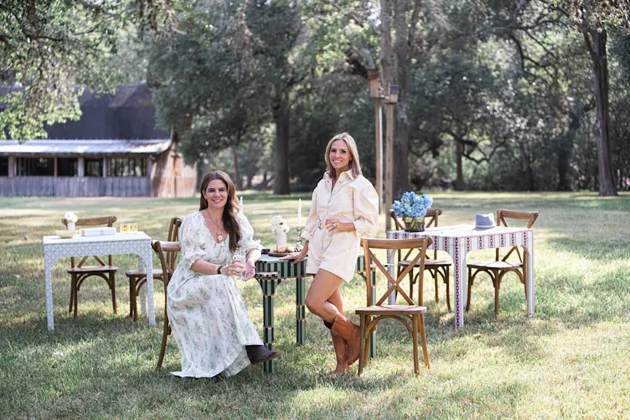 Katie Kime and Elizabeth Autenreith of Avella Interiors seated among the game tables