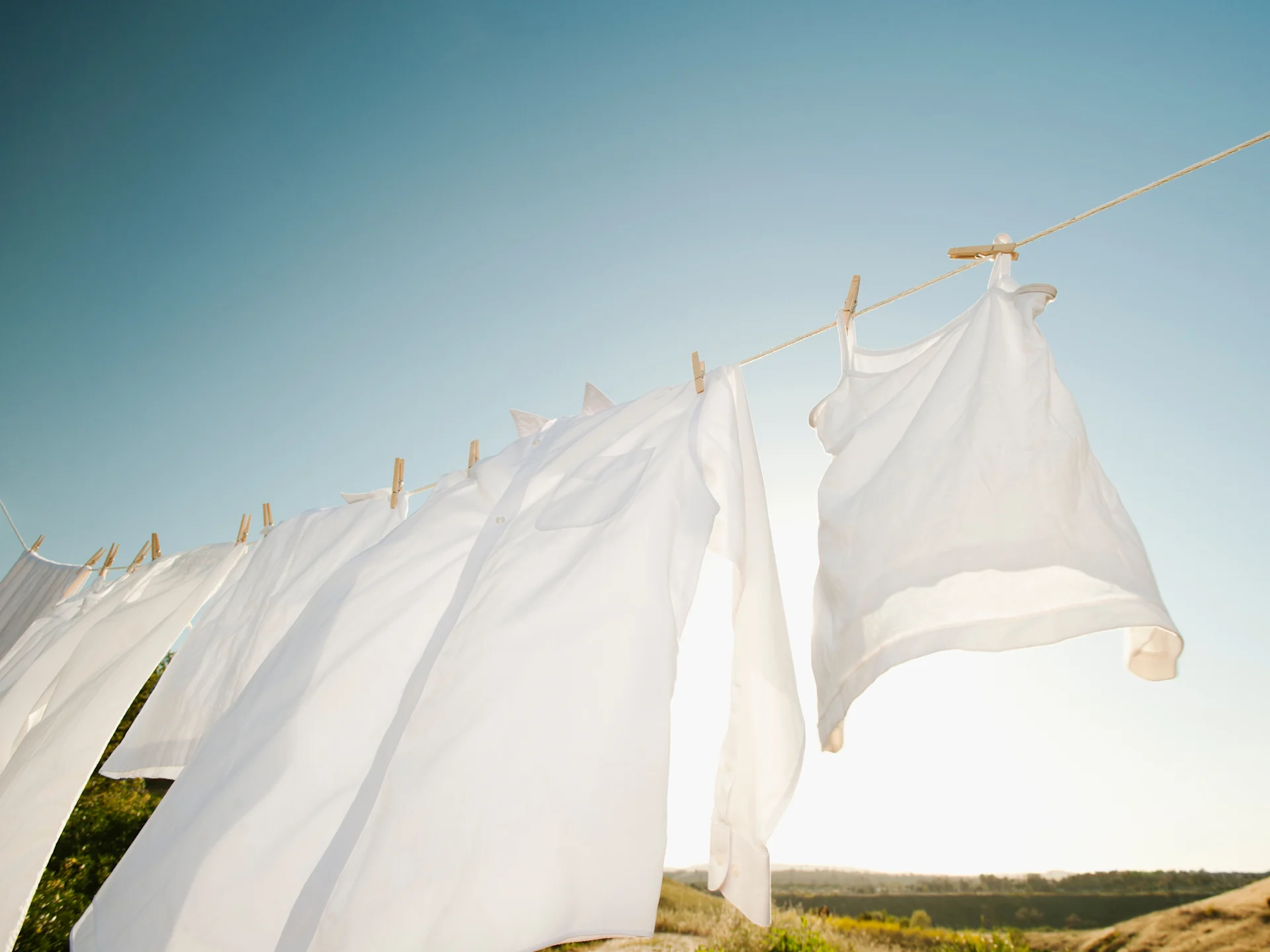 Fresh White Laundry Hanging Outdoors On A Line