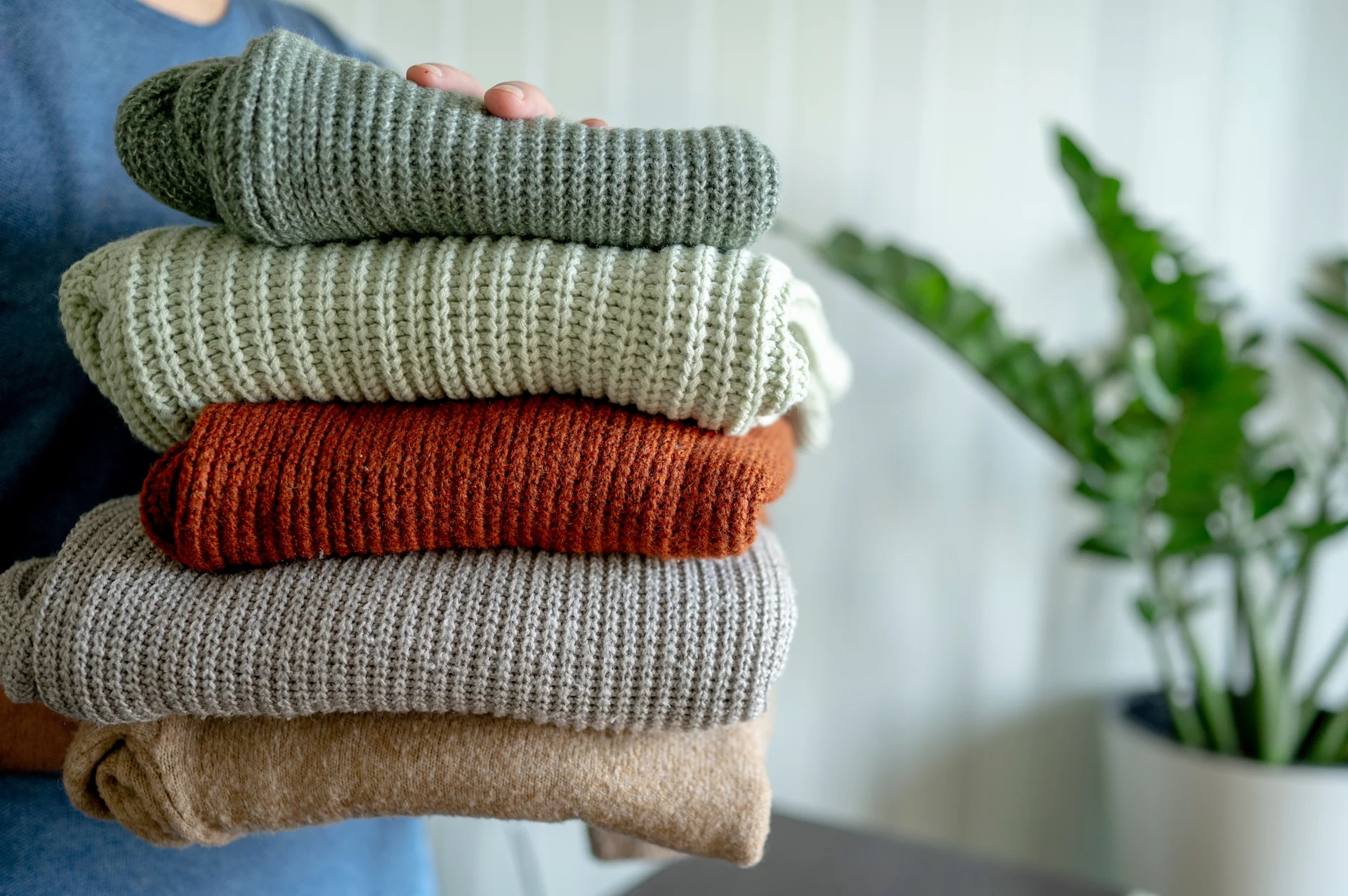 Stack Of Folded Knitted Sweaters In Various Colors