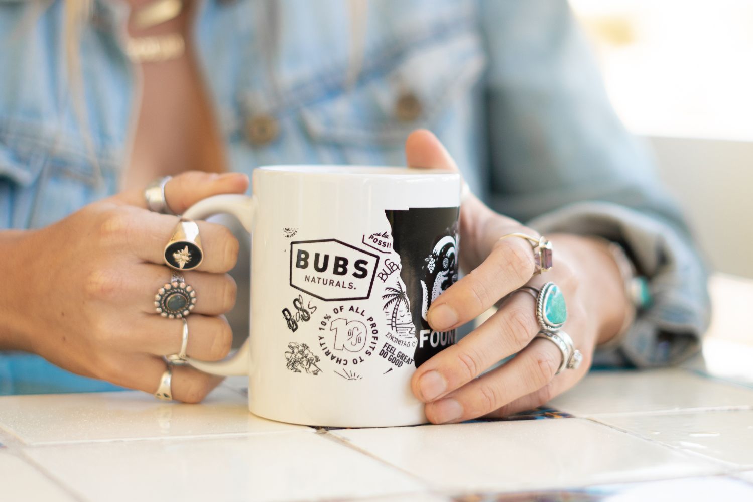 Girl Drinking coffee in a BUBS Naturals Mug