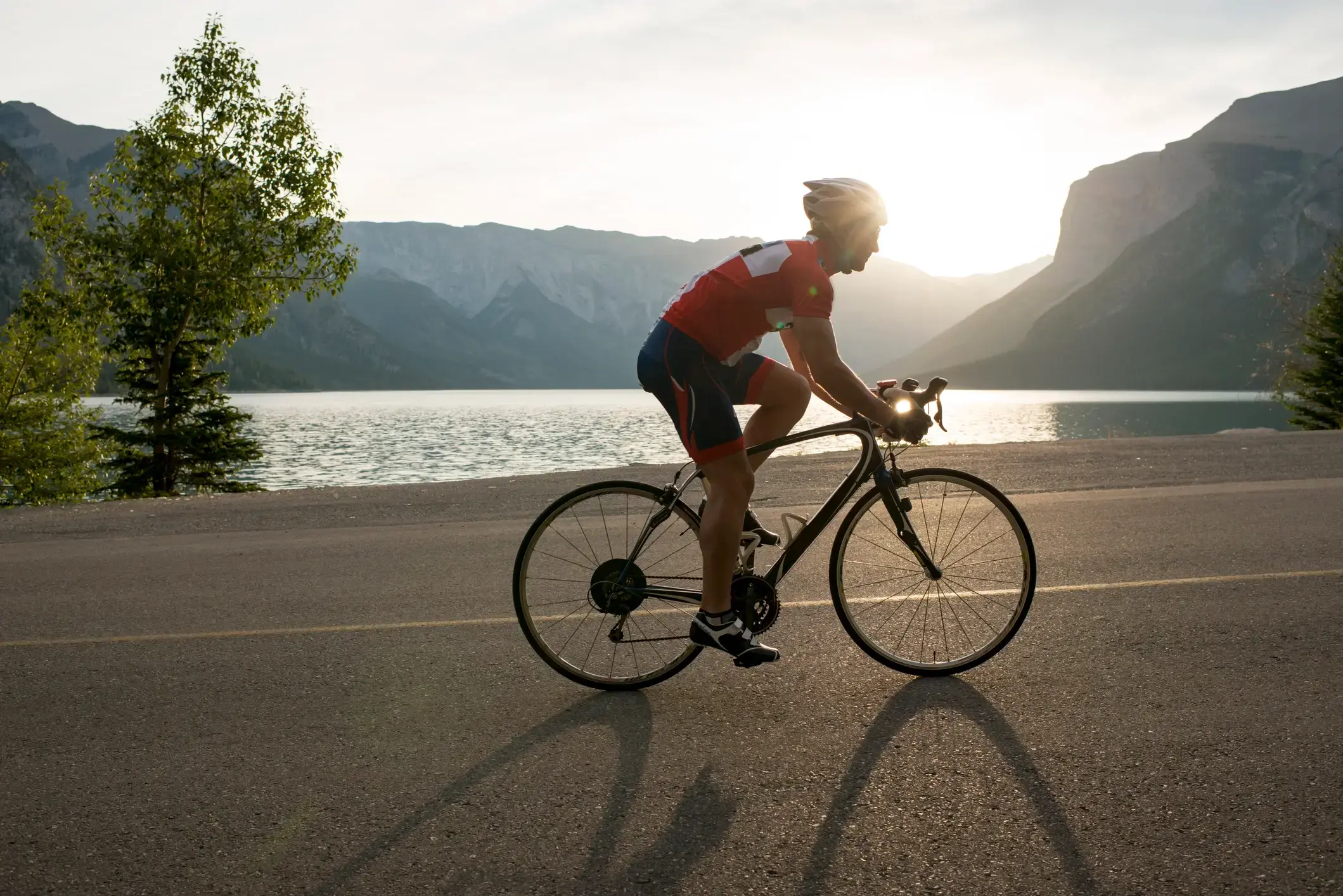 A man riding his bike along a mountain road.