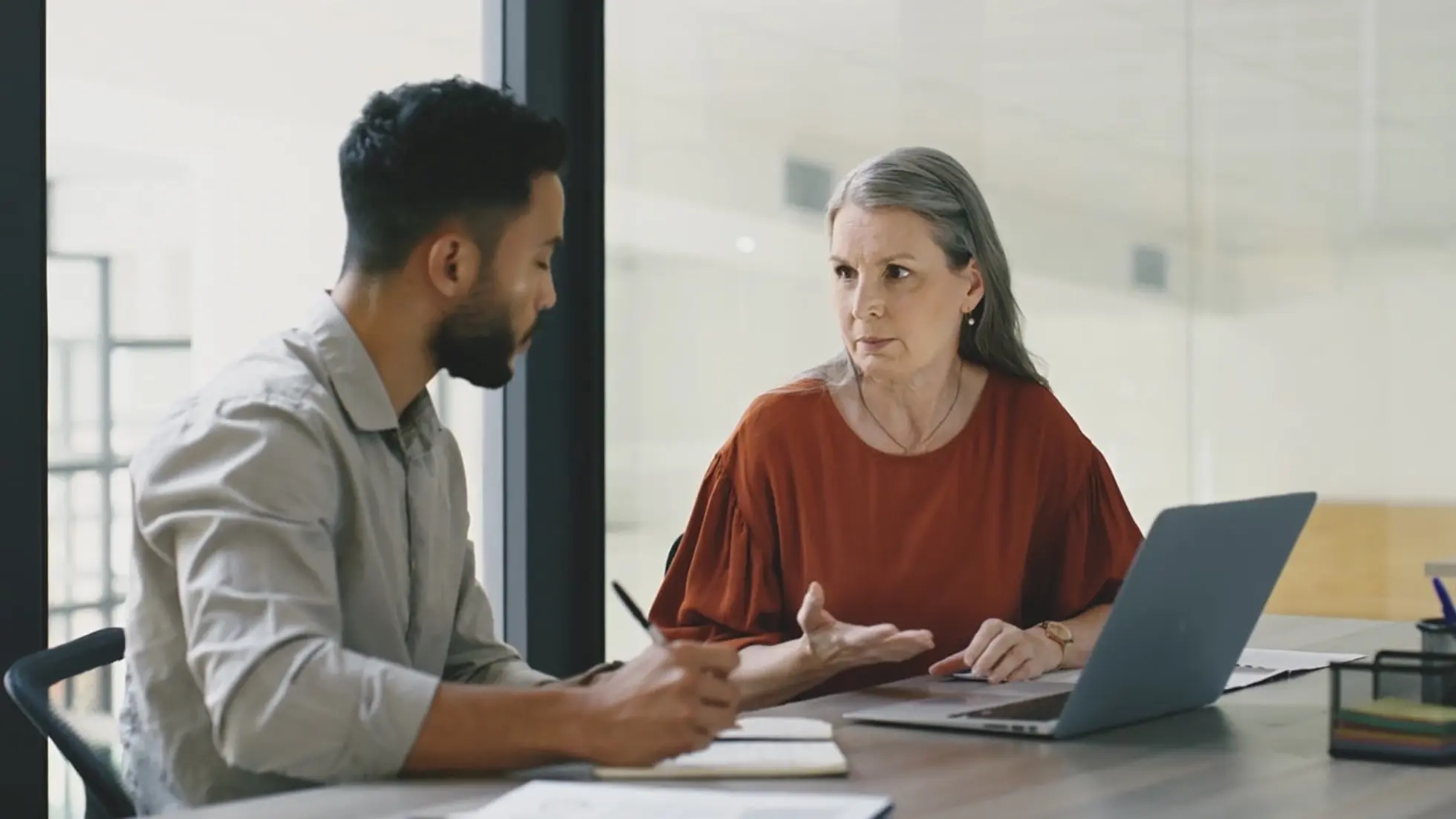 A doctor and a patient having a conversation in a hospital office