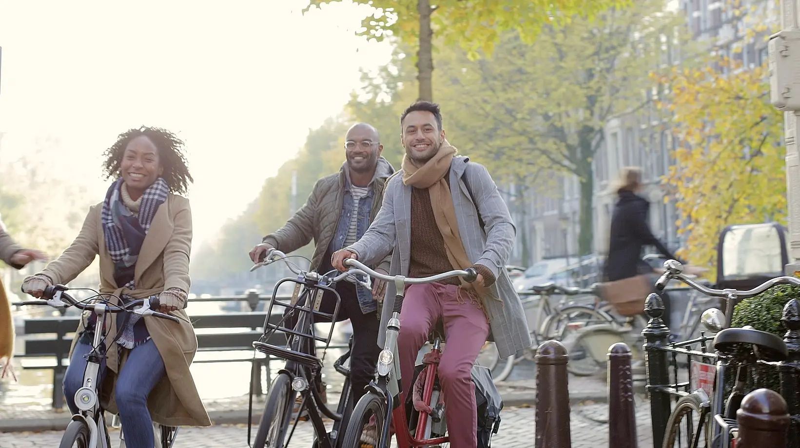 A group of students riding their bicycles together by the water.