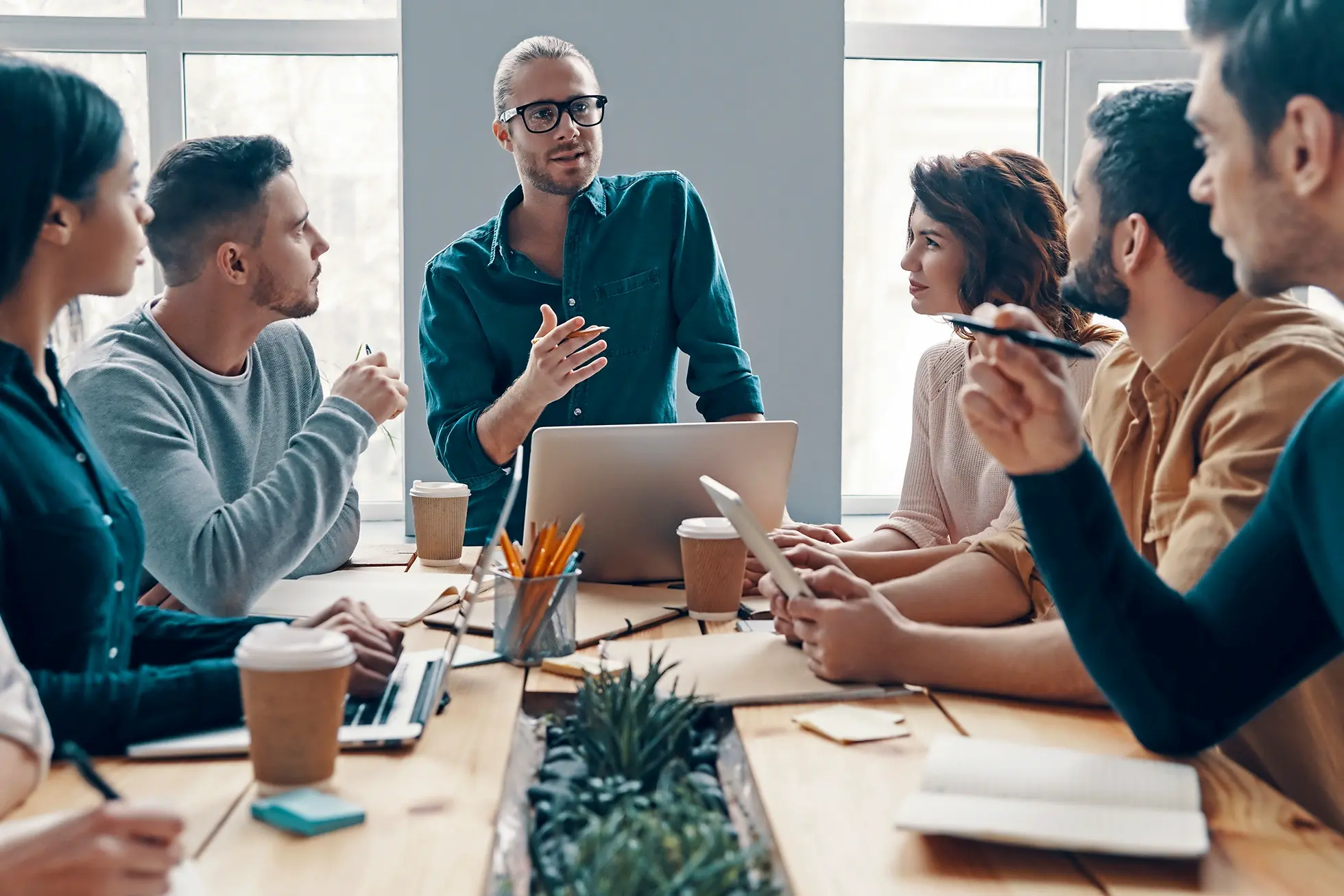 A group of people having a meeting in a conference room.