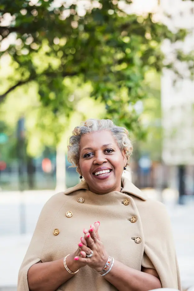 A mature afro-american woman walking across campus.