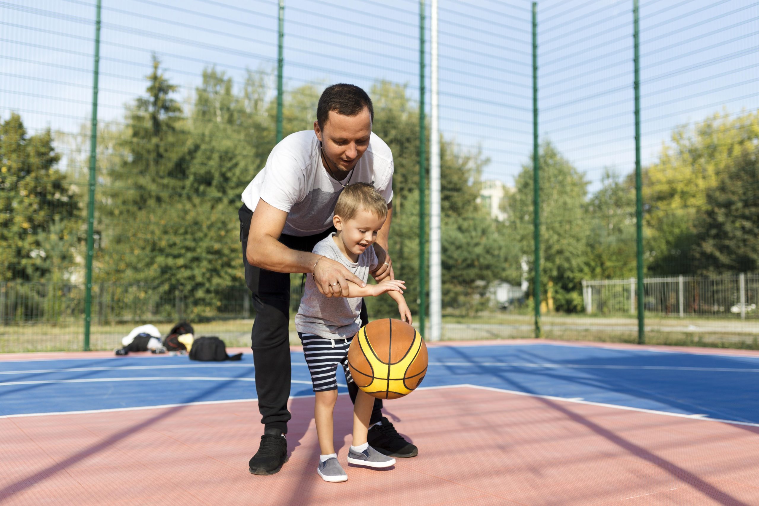 happy-monoparental-family-learning-how-play-basketball-scaled