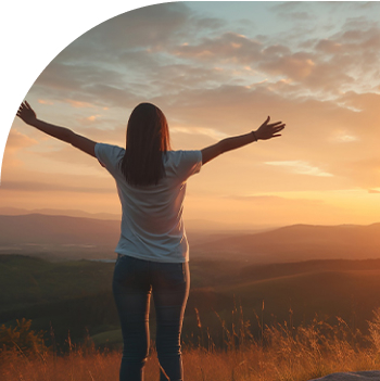 woman stretching arms viewing the sunset