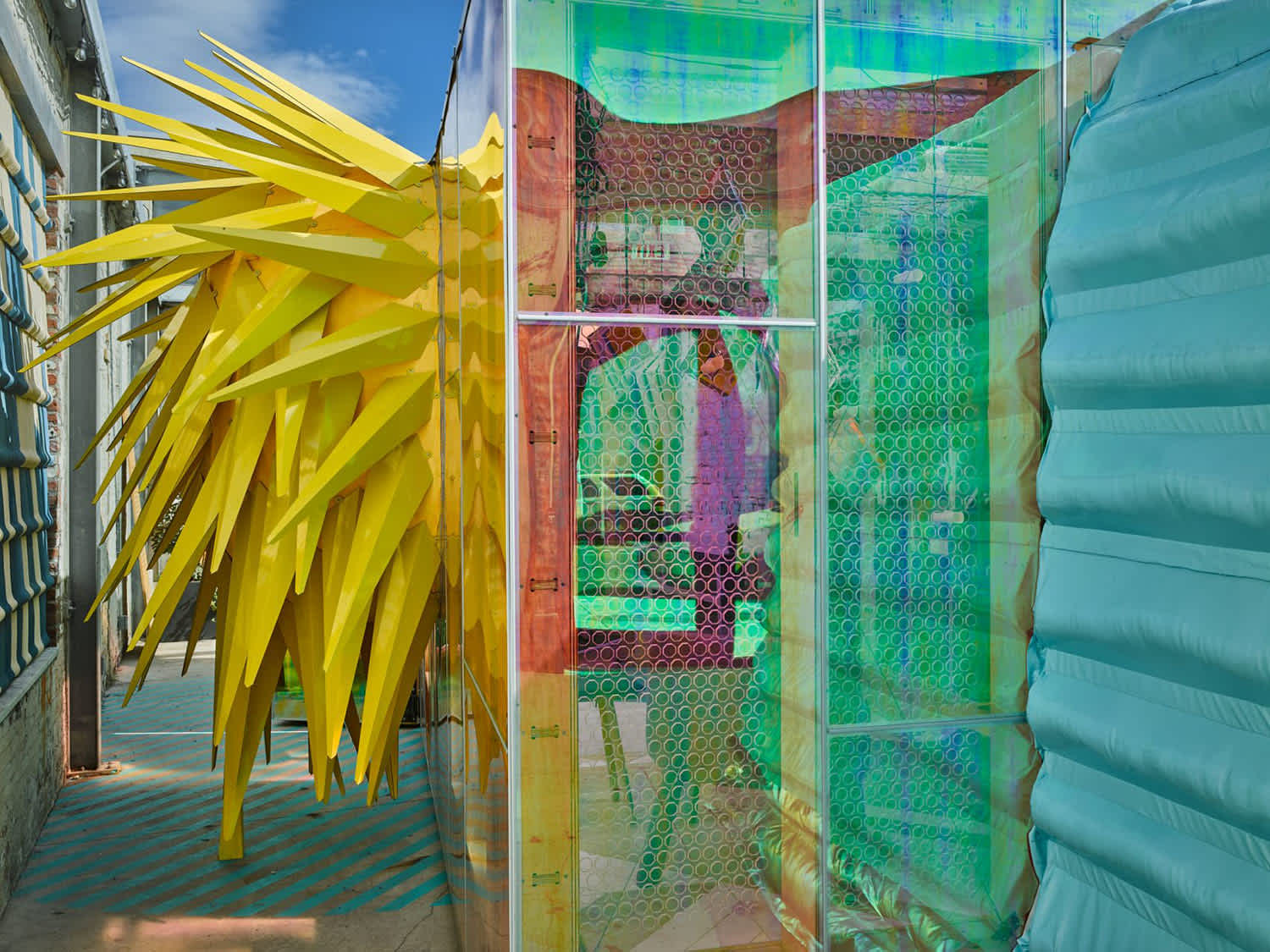 Metal spikes and iridescent glass exterior of the pop up installation Mini Living, designed by Bureau V, located in Brooklyn, NY
