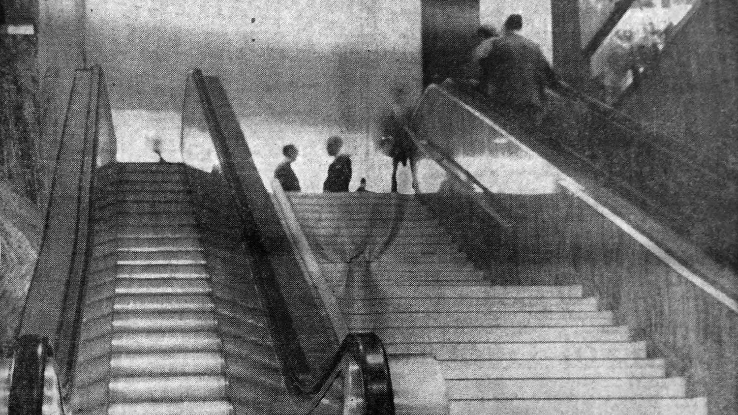 Gleaming escalators transport some passengers (original caption), for "The Performance of Shame: The Desegregation Renovations of Downtown Atlanta" by Peter Zuspan