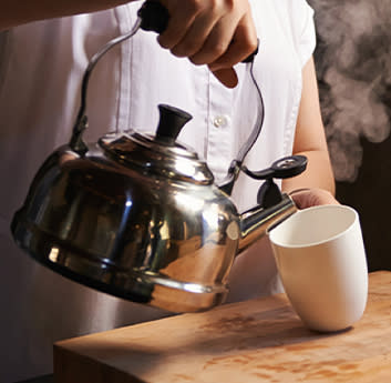 Pouring tea in a kettle image