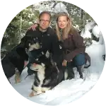 A dog named Madison posing with her fellow dog and his furparents before suffering from a fatal condition that is Salmon Poisoning.