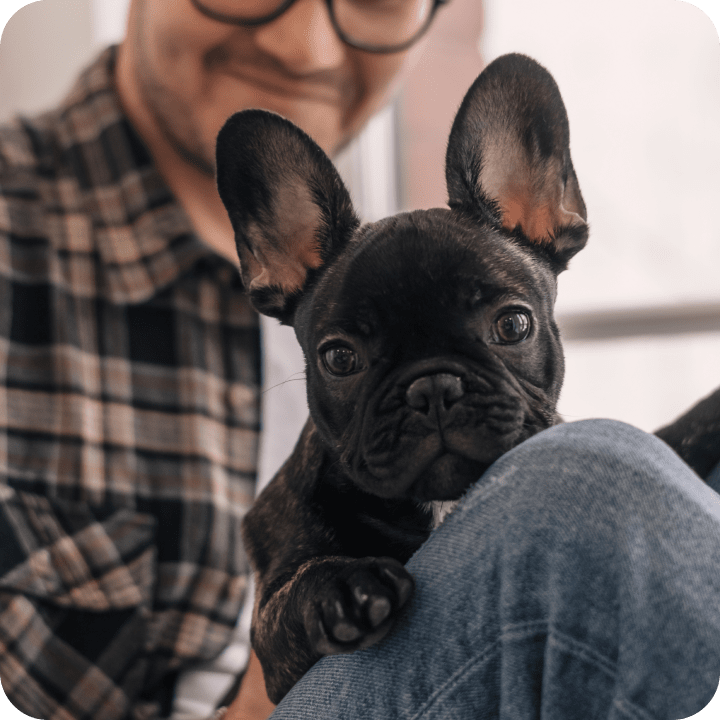 A man with his glasses posing with his dog 